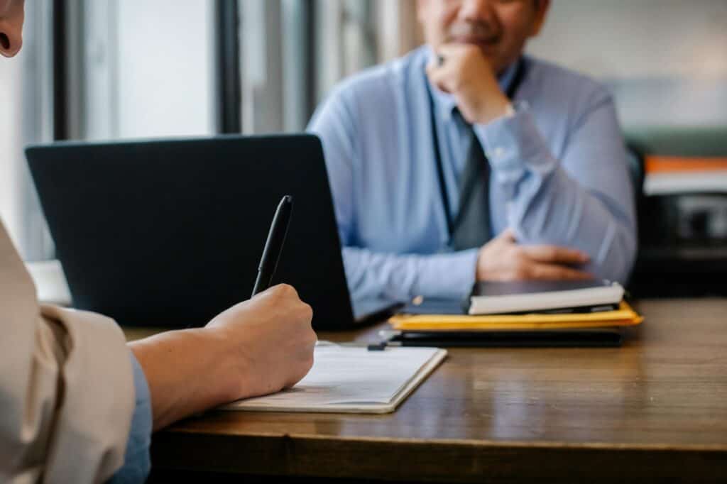 A job interview where a woman is filling out a form