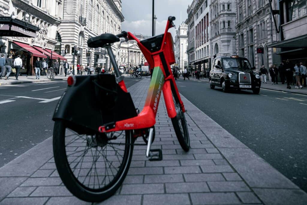 A bike parked in a street lined with variety of shops in the concept of services and amenities in West London.
