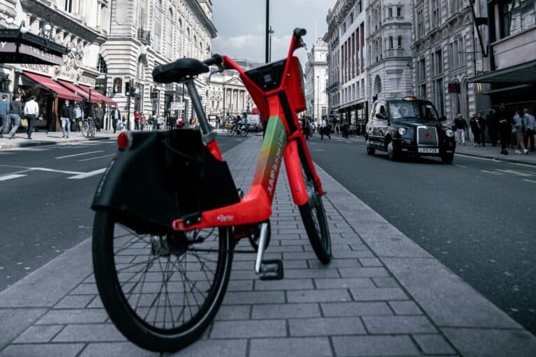 A bike parked in a street lined with variety of shops in the concept of services and amenities in West London.