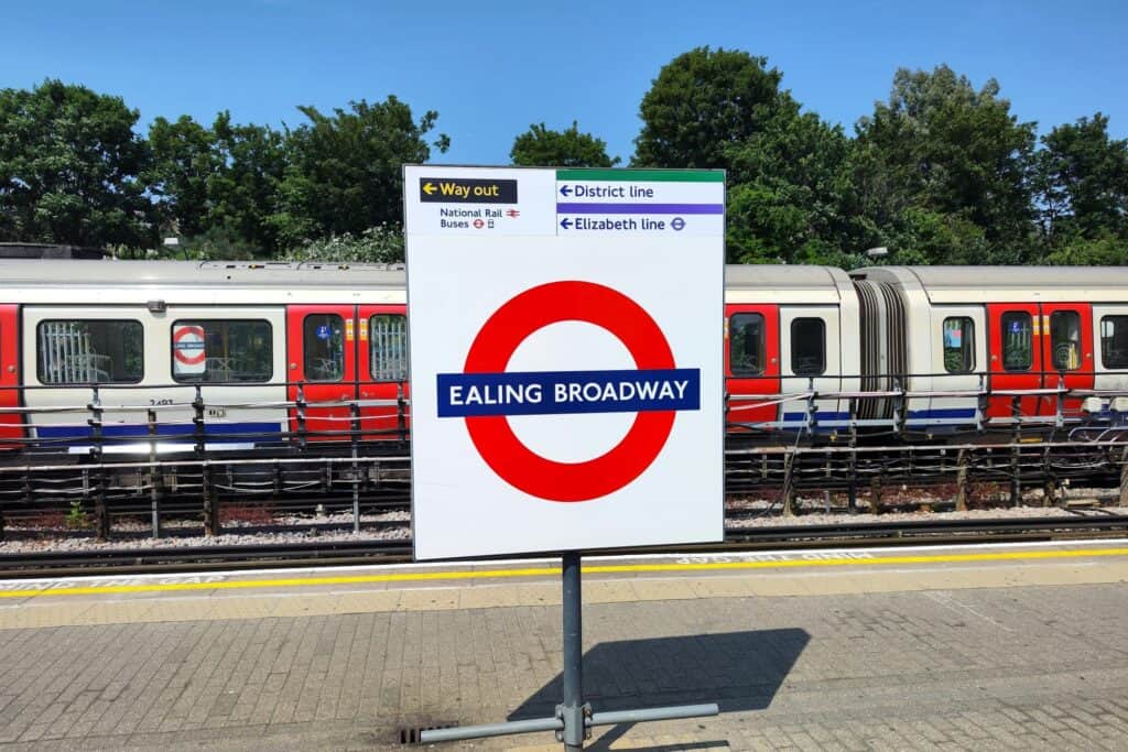An Ealing Broadway Underground Station sign under the sunlight