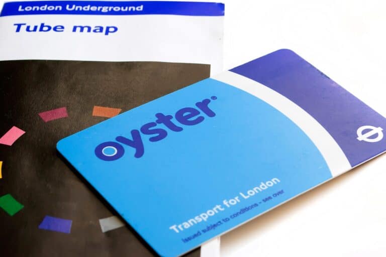 An Oyster card and Tube map on the table in the concept of public transport in the West London area.