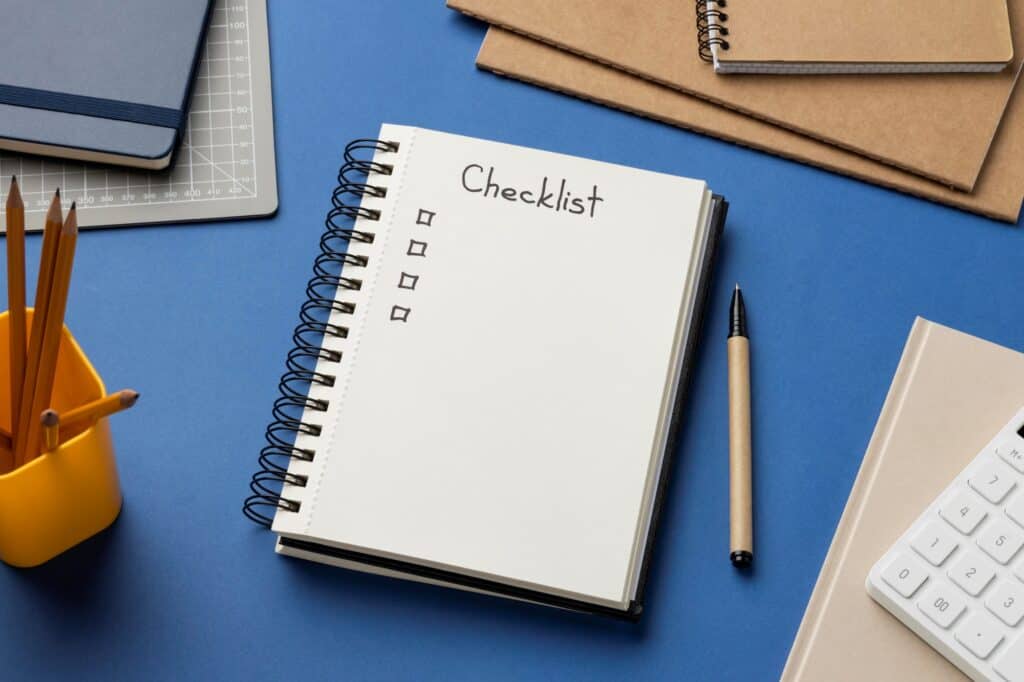 A notebook as a checklist in the concept of 'How to Create a Moving Checklist for Your Move to West London'.