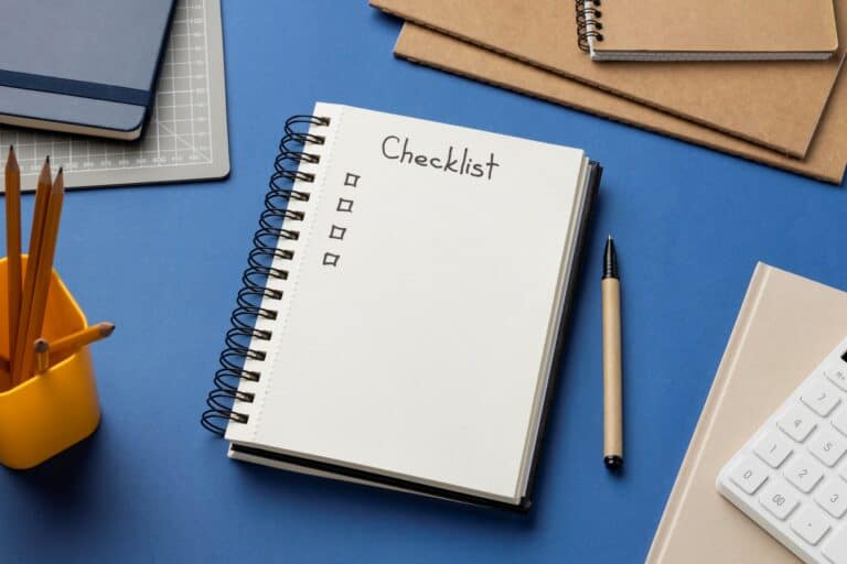 A notebook as a checklist in the concept of 'How to Create a Moving Checklist for Your Move to West London'.