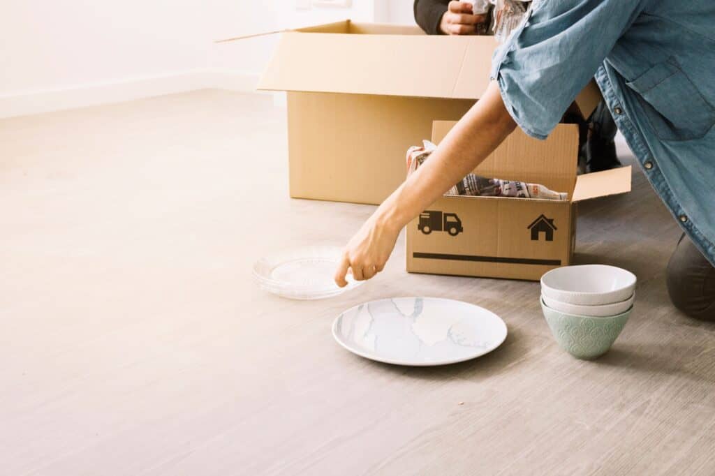 Cropped image of a couple unpacking boxes in their new house
