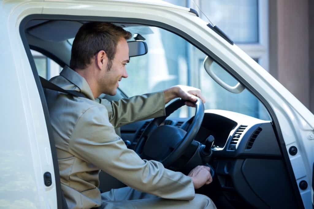 A van driver starting the engine in the concept of fuel surcharges as one of the hidden costs