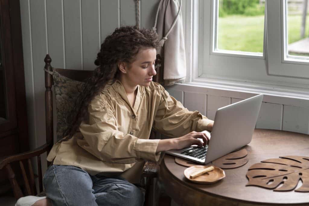A young woman researches for removals company on her laptop