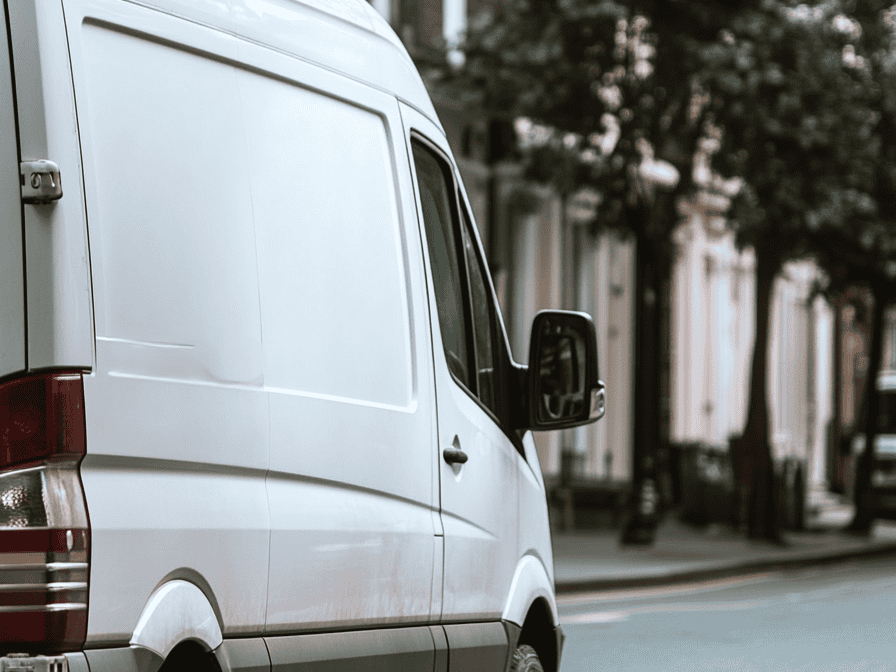 A white home removals van speeding the West London street